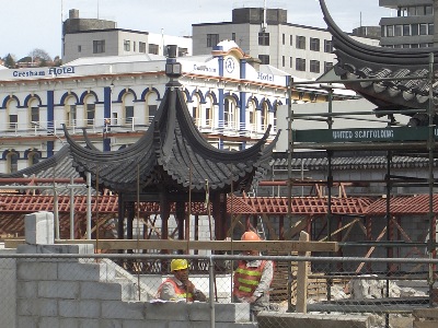 Here, we can distinctly note the roof lines and also the Chinese artisans are working on raising the Half Pavilion on the Hill.