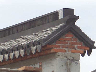 A close-up of the Chinese Garden Wall top, above the " Scholar's Study."