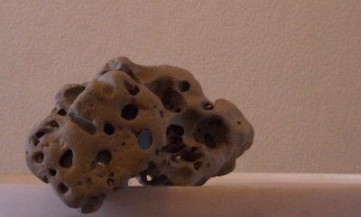 A naturally " holed, " piece of rock.