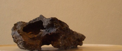 A dark piece of rock, that suggests a rather dark and / or  deep place.